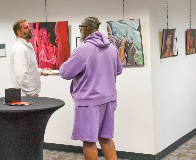 A meeting beside the artwork.