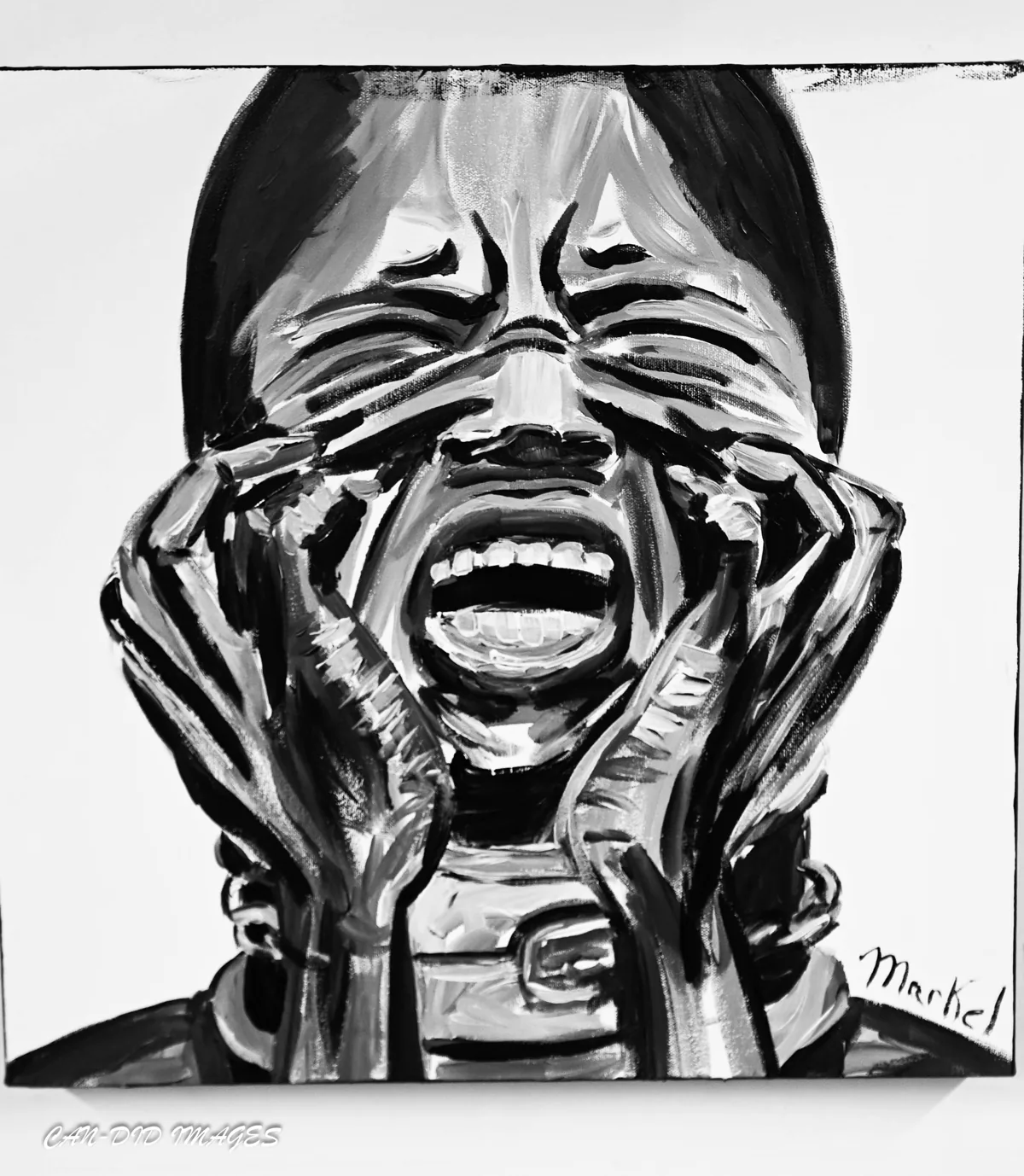 Monochrome portrait with hands framing an expressive face.