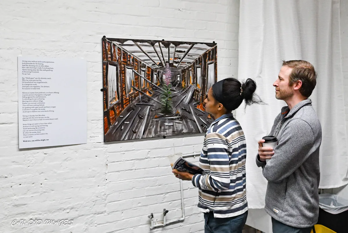 Exhibition visitors studying a painting together.