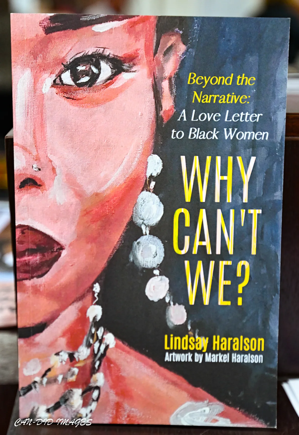 The cover of Why Can’t We? by Lindsay Haralson displayed at the exhibition.
